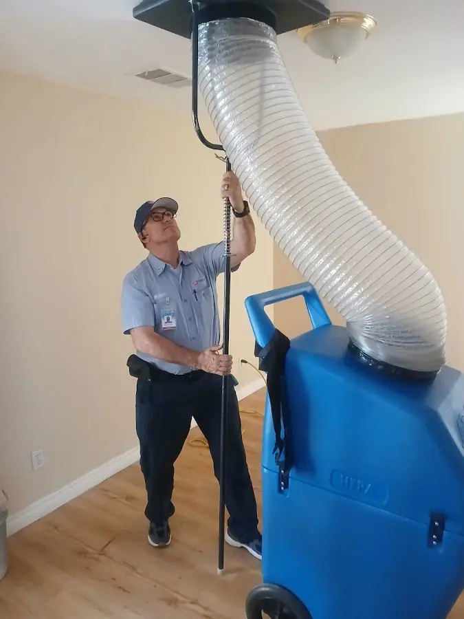 Furnace Tune-Up technician using HEPA equipment in Riviera Beach